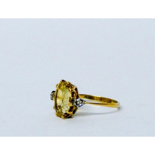 742 - An Art Deco yellow sapphire and diamond ring, large oval mixed cut yellow sapphire with two brillian... 