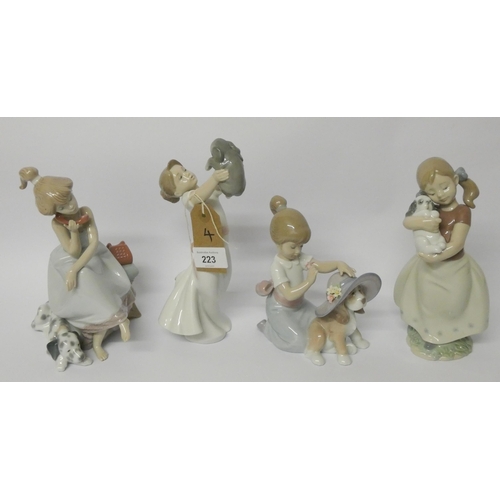 223 - A collection of Lladro figurines, to include Girl on telephone, (4).