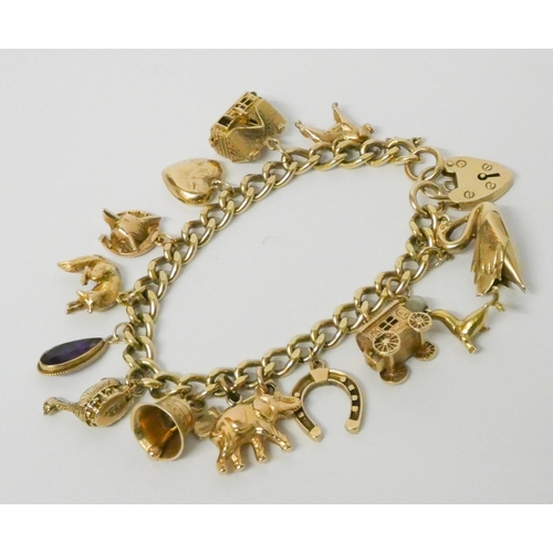 717 - A 9ct gold charm bracelet, set numerous charms, with padlock fastening 58 grams