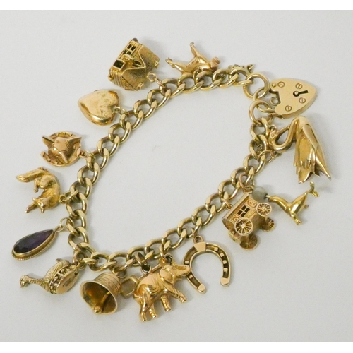 717 - A 9ct gold charm bracelet, set numerous charms, with padlock fastening 58 grams