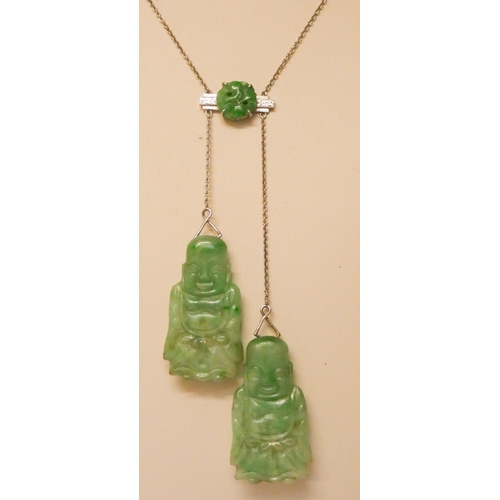 730 - An Art Deco carved jade asymmetric pendant necklace, in 9ct white gold, set with two carved jade Bud... 