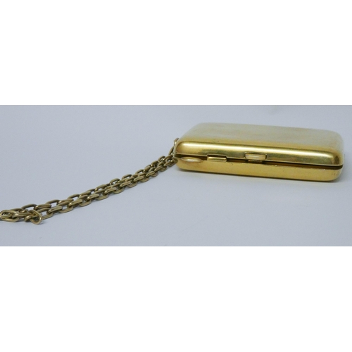 646 - A vintage American silver gilt ladies necessaire compact, suspended from a chain, with mirror, doubl...