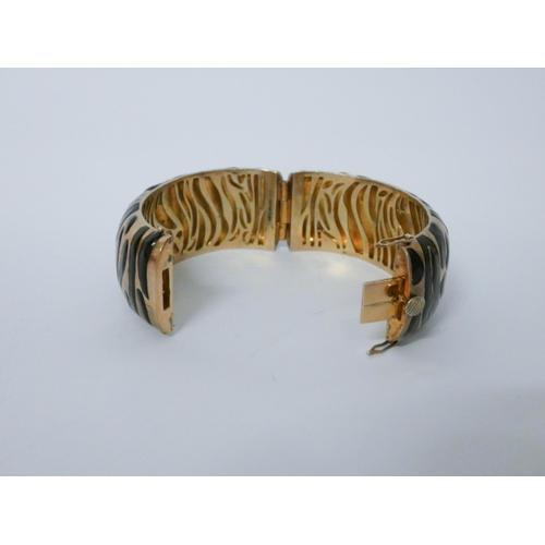 648 - A striking silver gilt and black enamelled bangle with animal print design. Hallmarked...