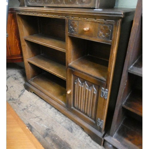 52 - A linen fold carved oak bookcase fitted shelves, drawer and cupboards, 3' wide...