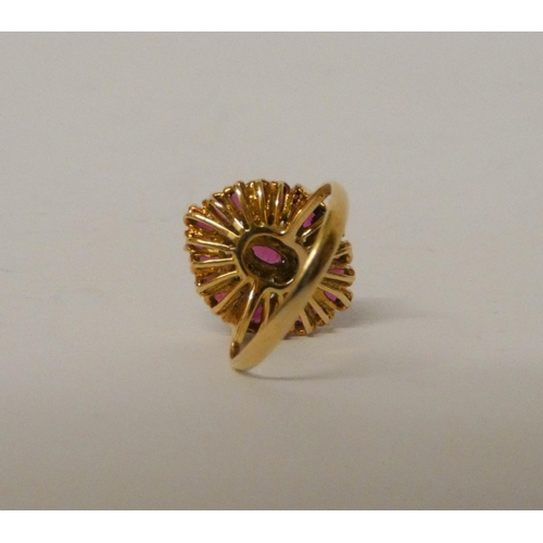 777 - An 18ct yellow gold ruby and diamond modern cluster ring. Ring size L