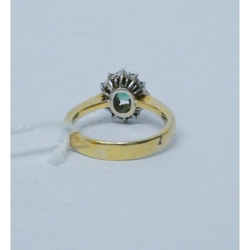 781 - An emerald and diamond oval cluster ring, on 18ct yellow gold band, hallmarked, ring size O