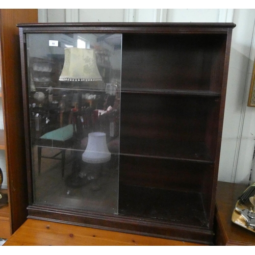 44 - A mahogany framed bookcase with sliding glass doors