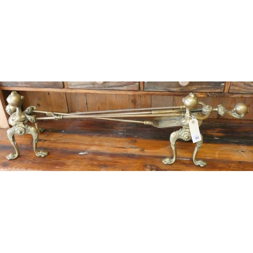 335 - A pair of Victorian brass fire dogs and matching implements