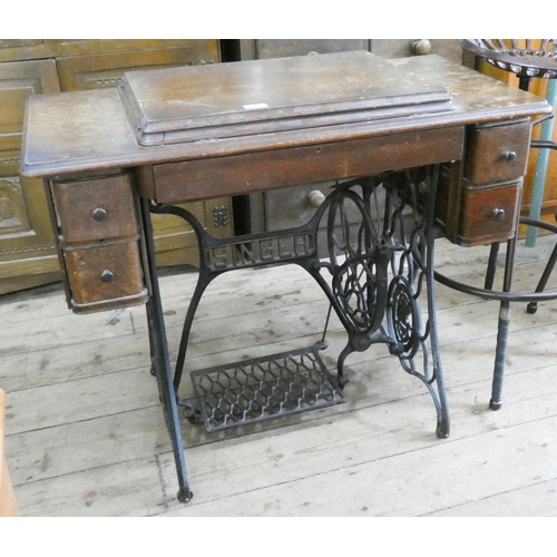 19 - A Singer treadle sewing machine in oak cabinet, fitted drawers