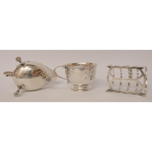 503 - Silver toast rack, a sauce boat and a silver christening cup. All hallmarked, Gross weight of three ... 