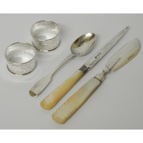 512 - Pair of silver hallmarked napkin rings, a silver tea spoon and two silver bladed knives with mother ... 