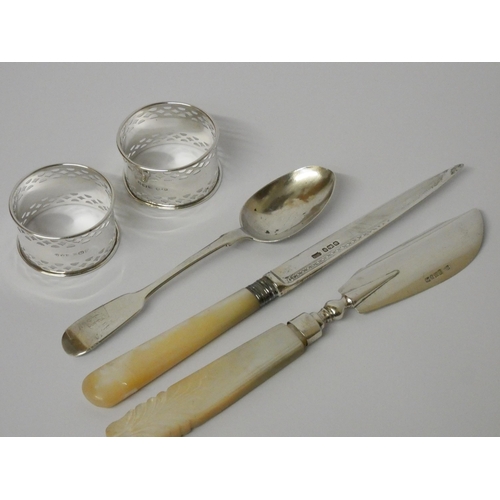 512 - Pair of silver hallmarked napkin rings, a silver tea spoon and two silver bladed knives with mother ... 