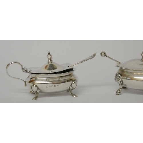 517 - Two hallmarked silver mustards, both with blue glass liners and spoons