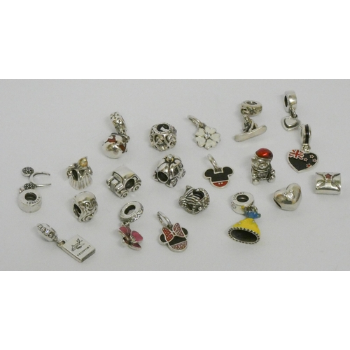 559 - Pandora - a large collection of 20 silver charms, some Disney with enamel decoration. Marked Pandora... 