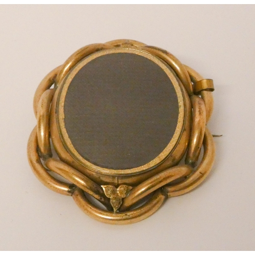 563 - Large Victorian oval mourning brooch. With glazed front and back panels