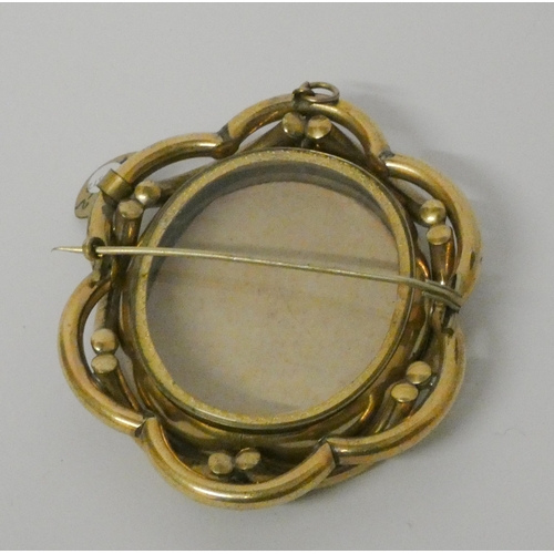 563 - Large Victorian oval mourning brooch. With glazed front and back panels