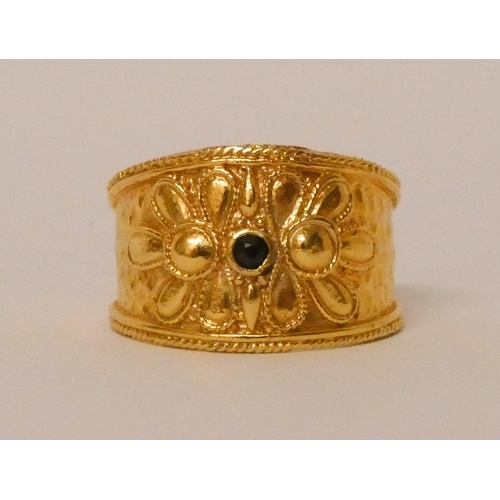 570 - A Greek yellow gold wide band Etruscan style ring, set with a sapphire, marked 585 for 14ct. Ring si... 