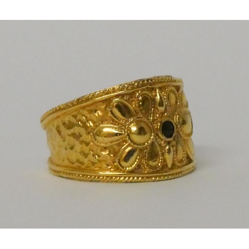 570 - A Greek yellow gold wide band Etruscan style ring, set with a sapphire, marked 585 for 14ct. Ring si... 