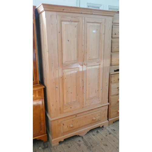 63 - A Victorian style pine two door wardrobe on a drawer base, 3'6 wide