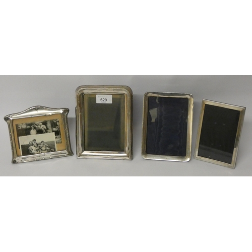 529 - A collection of four hallmarked silver rectangular photograph frames