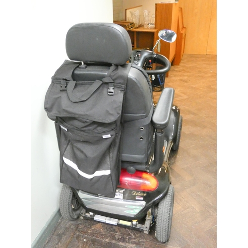 802 - A black and silver Shop Rider Deluxe, four narrow wheeled mobility scooter, with front basket, rear ... 