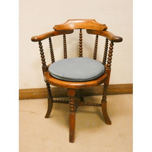 458 - A mahogany tub shaped desk chair with turned spindle back and cane seat