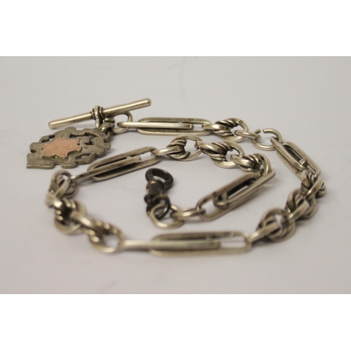 479 - A silver fancy link albert chain with T bar and medallion