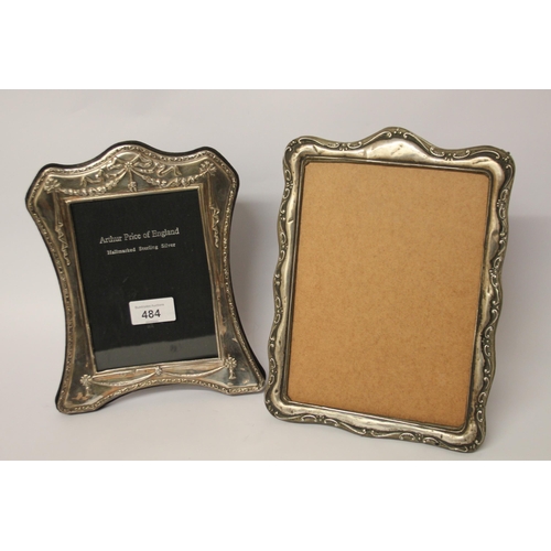 484 - Two silver easel type photo frames. Larges t measures 26 cms approx