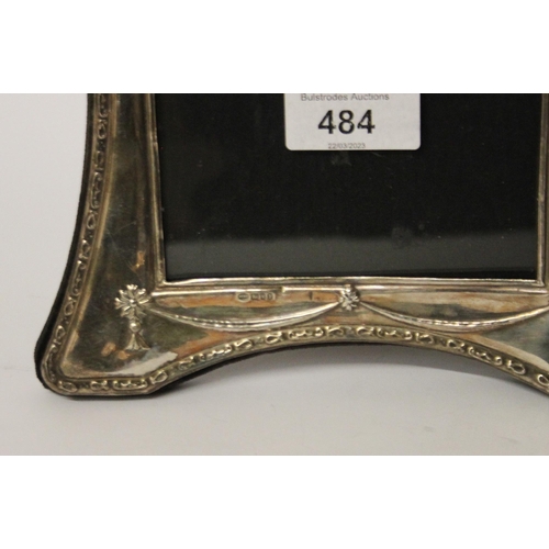 484 - Two silver easel type photo frames. Larges t measures 26 cms approx