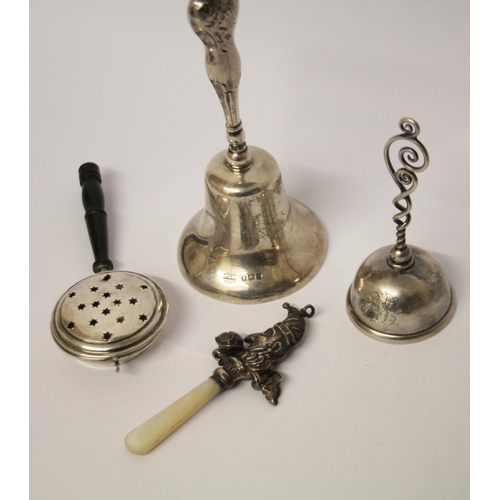 485 - Two hallmarked silver table bells, a miniature novelty bed warmer and an Edwardian silver and mother... 