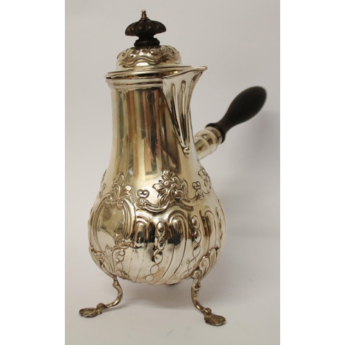 495 - Edwardian silver café au lait pot, with ebony handle and finial, embossed floral and half lobed desi... 