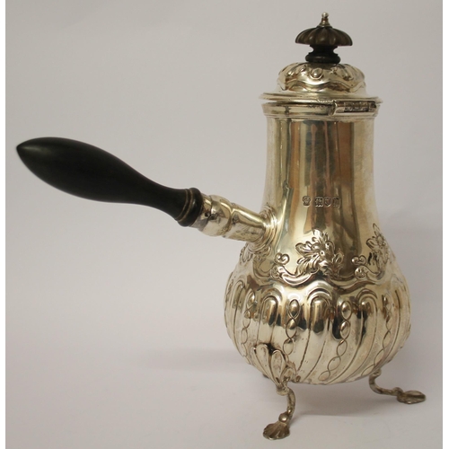 495 - Edwardian silver café au lait pot, with ebony handle and finial, embossed floral and half lobed desi... 