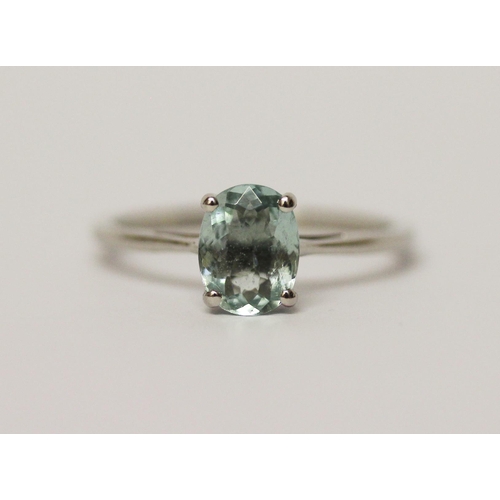 568 - An aquamarine ring, the oval claw set aquamarine on hallmarked platinum band, ring size P