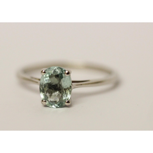 568 - An aquamarine ring, the oval claw set aquamarine on hallmarked platinum band, ring size P