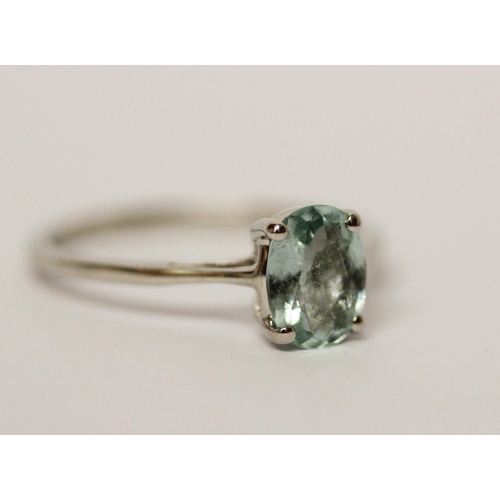 568 - An aquamarine ring, the oval claw set aquamarine on hallmarked platinum band, ring size P