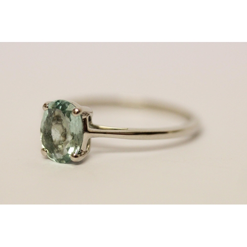 568 - An aquamarine ring, the oval claw set aquamarine on hallmarked platinum band, ring size P