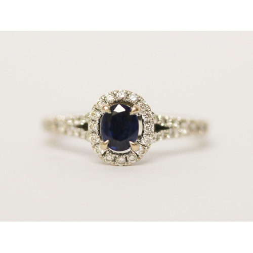 578 - Modern 18ct white gold sapphire and diamond oval cluster ring. Diamond weight 0.22 carats marked in ... 