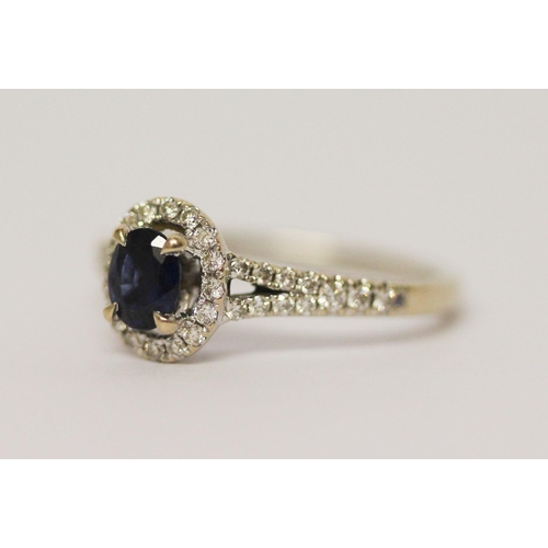 578 - Modern 18ct white gold sapphire and diamond oval cluster ring. Diamond weight 0.22 carats marked in ... 