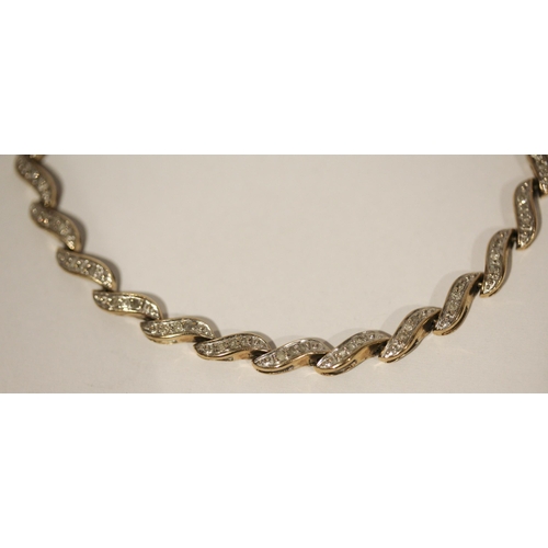 588 - A modern 9ct yellow gold and diamond set bracelet, 19cms long, gross weight 7.2 grams