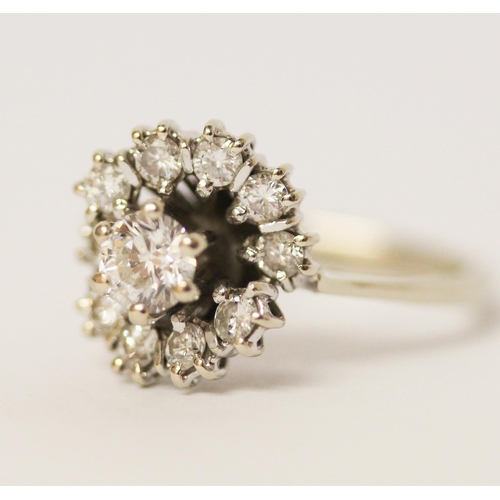 589 - Diamond cluster ring, mid-century setting in an off set design, unmarked white gold, ring size M