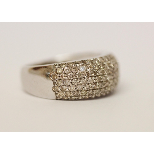 591 - A modern wide diamond set band on hallmarked 18ct white gold, ring size M