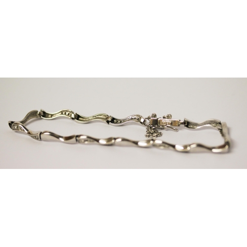 593 - Modern 18ct white gold diamond set bracelet, with box clasp and safety chain, hallmarked gross weigh... 