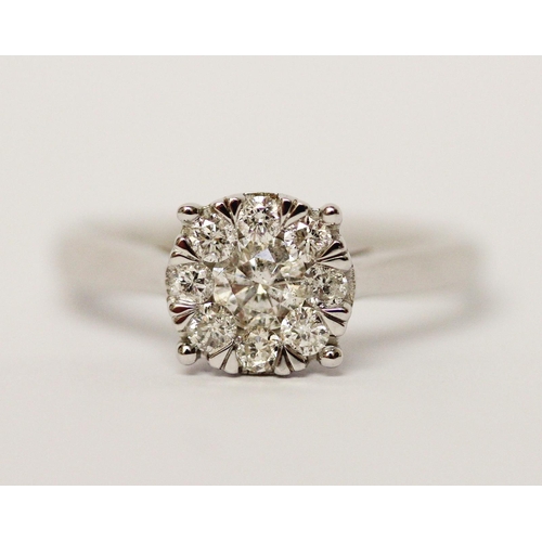 594 - Modern 9ct white gold diamond cluster ring, set with 0.5 carats of diamonds. Ring size M