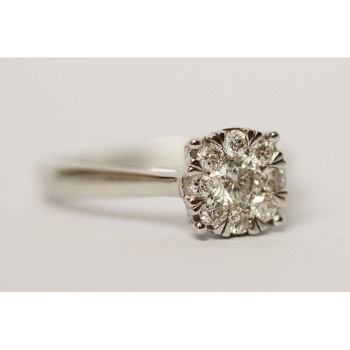 594 - Modern 9ct white gold diamond cluster ring, set with 0.5 carats of diamonds. Ring size M