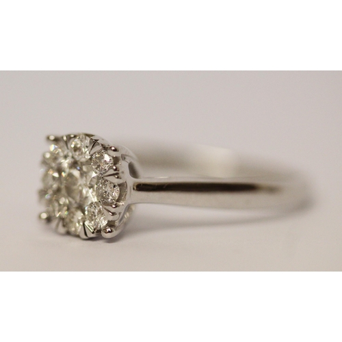 594 - Modern 9ct white gold diamond cluster ring, set with 0.5 carats of diamonds. Ring size M