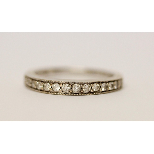 597 - 18ct white gold half hoop diamond set eternity ring, 0.25 carats, marked 750. Ring size L