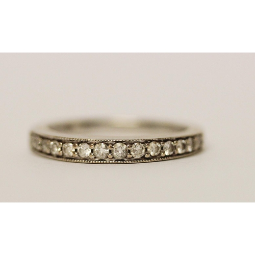 597 - 18ct white gold half hoop diamond set eternity ring, 0.25 carats, marked 750. Ring size L