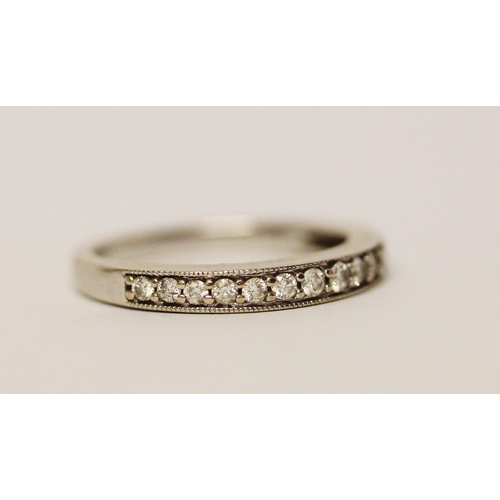 597 - 18ct white gold half hoop diamond set eternity ring, 0.25 carats, marked 750. Ring size L