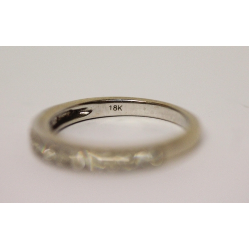 597 - 18ct white gold half hoop diamond set eternity ring, 0.25 carats, marked 750. Ring size L