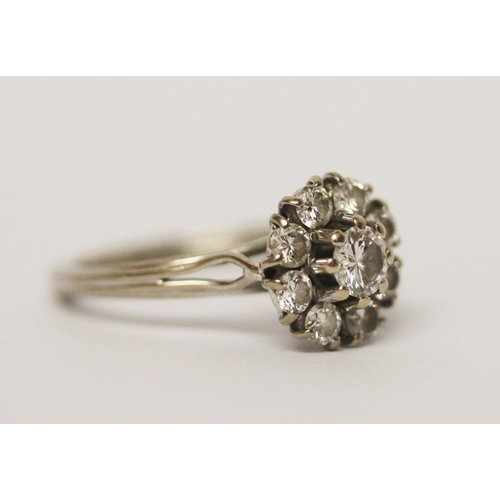 620 - A diamond circular cluster ring, on hallmarked 18ct white gold band. Ring size M